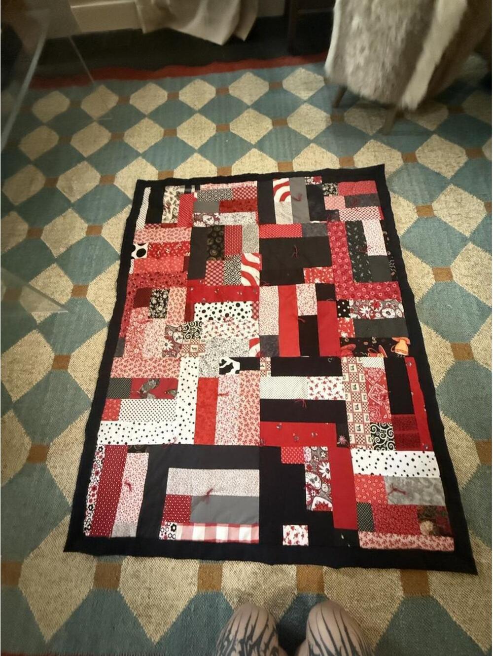 Handmade lap quilt with red, black, and white patchwork 39 x 39